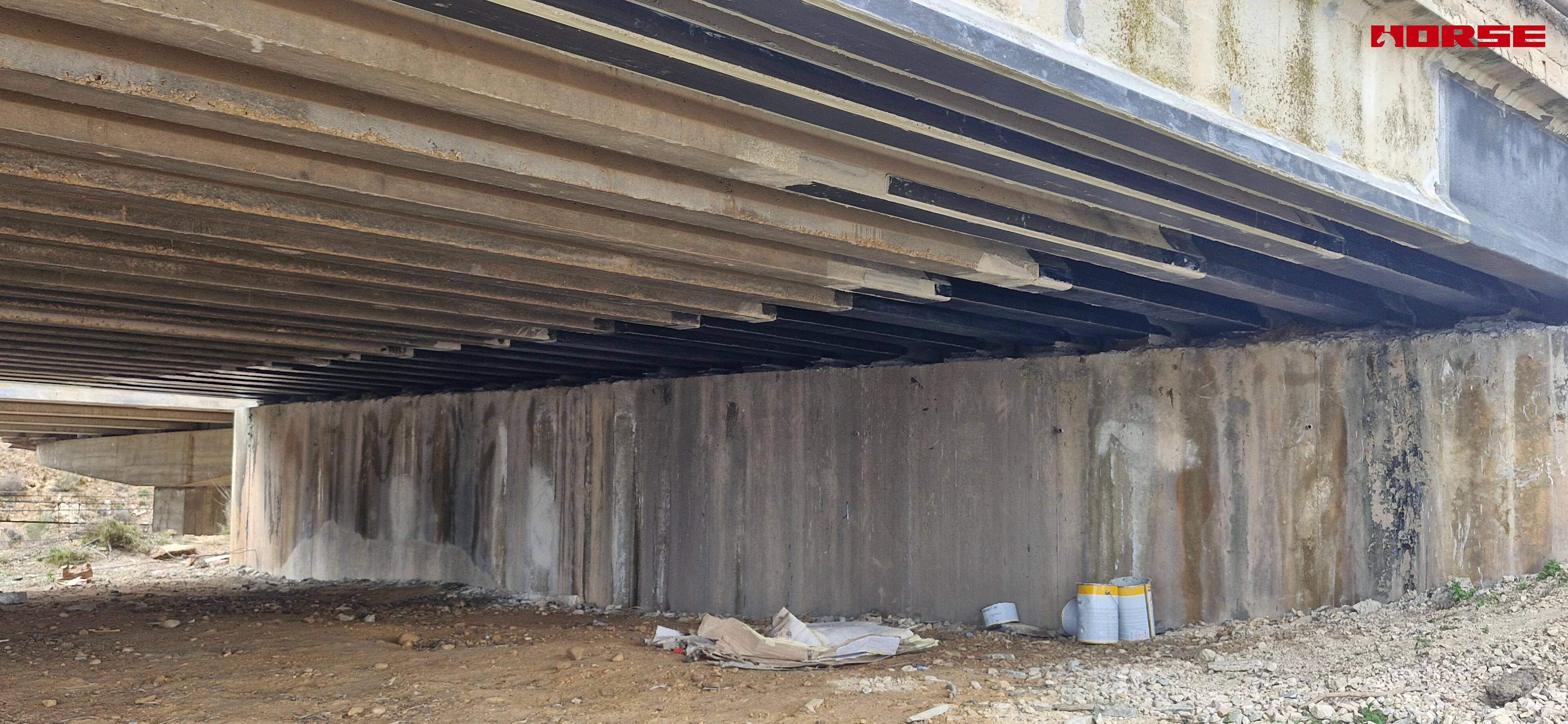 Strengthening of a Prestressed Concrete Multi-Girder Bridge with CFRP Laminate and U-warp
